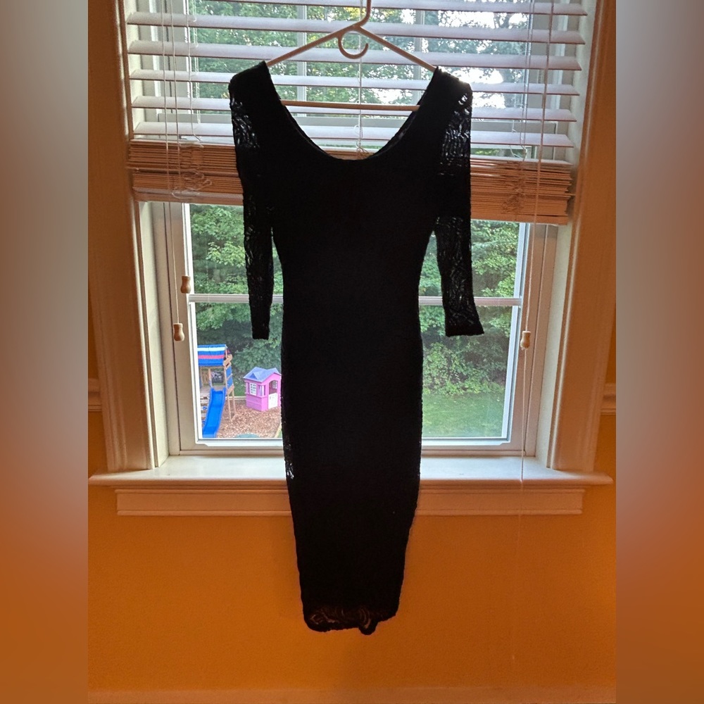 Black fitted mid length dress.